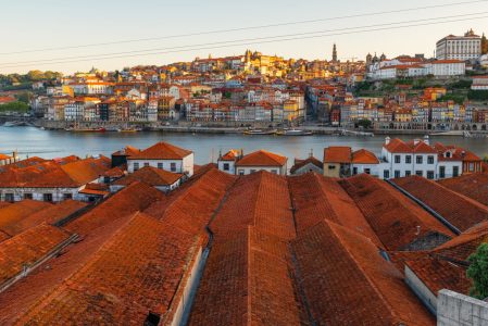 Porto, Portugal old town on the Douro River with orange rooftops of Vila Nova de Gaia buildings at sunrise. Medieval architecture of Oporto downtown. Travel destination